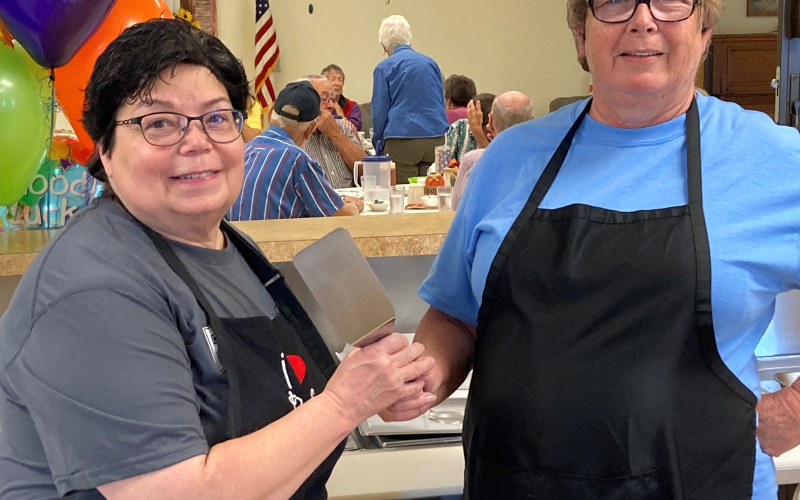 Dianne Von Eye (pictured at right) passes her spatula to new ROCS employee Marla Ness (left) during Von Eye’s last day serving up meals at the Wessington Springs Senior Center. Read more in “Senior Center Moments” on PAGE SEVEN DELIA ATKINSON / TRUE DAKOTAN