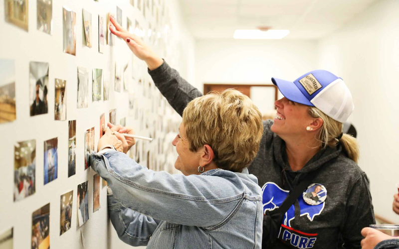 Historic Wessington Springs FFA Chapter photos adorned the walls of the hallway leading up to the shop. Community members, including Paulette Olson (left) and Hilary Grohs helped ID dozens of photos.
