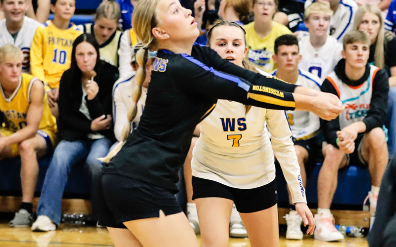 Raylee Fagerhaug gets under the volleyball during a homecoming victory in three.