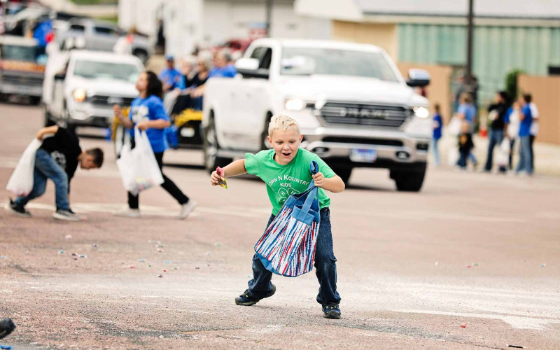  Will Arhart was among the many kids dashing for candy thrown along the route.