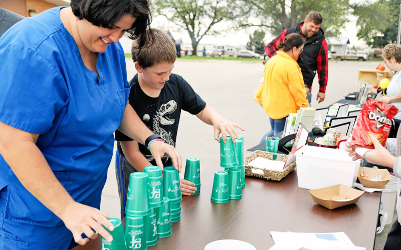 Avera Weskota Memorial Hospital Rad Tech Melissa Mentele and son Devin play one of the games featured at the Health Care Campus Block Party.