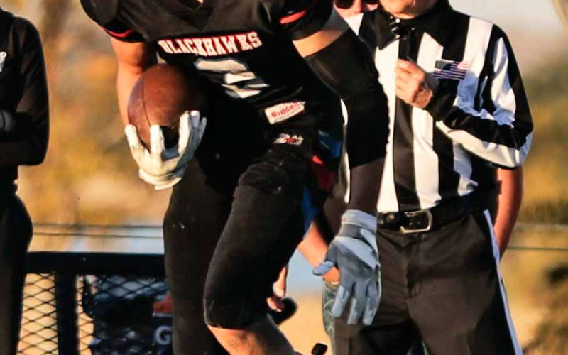 Brock Krueger runs the ball during first round playoff football action last Thursday.