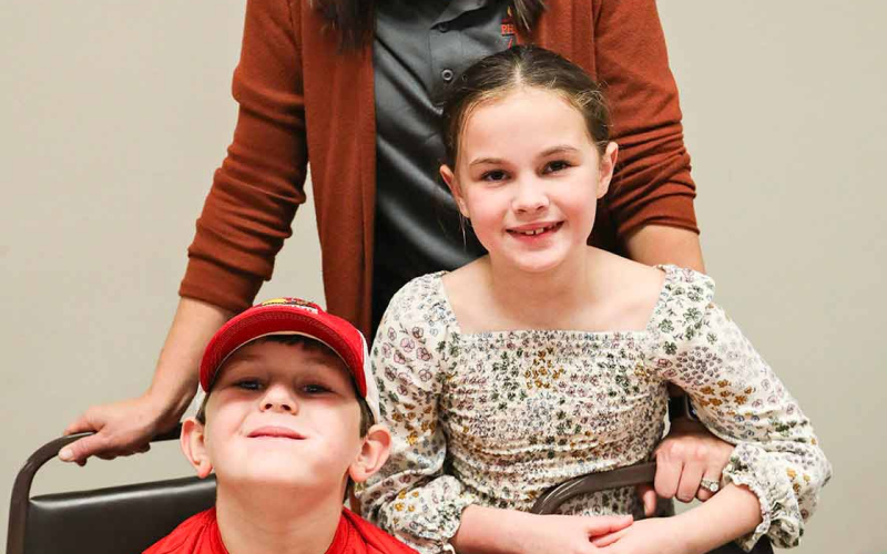 Cristin Weber, Precision Ag and Conservation Specialist, Pheasants Forever, Inc. and Quail Forever is shown at the banquet with her children Finley and Hadley.