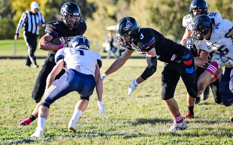 Brock Krueger launches into gear to create a path for Holden Havlik.