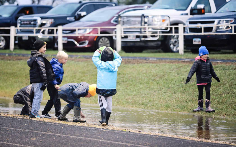 Standing water on and off the field made for challenging conditions for the Blackhawks and a source of fun for kids attending the game.