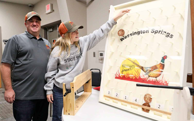 Aaron Roesler with daughter Lily are shown with one of the many games featured at the banquet.