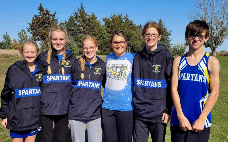 Shown with Coach Becky Krueger (center) are Spartans Cross Country state qualifiers Alexis Roesler, Abby Kolousek, Ella Kolousek, Masynn Mebius and Ranick Fjerstad.