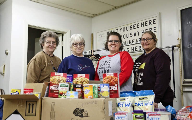 Shown left to right are: Food Pantry volunteers Janece Wetzel and Marcella Andersen, Laura Baker of Baker’s Design, Lisa Younie of Springs Food Market.