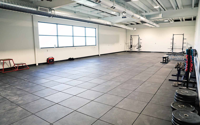 Student athletes helped move existing equipment from the old weight room to the new fitness center. While current exercise equipment will be moved into the fitness center soon, the spacious area has room for additional capacity to serve not only students but also community members.