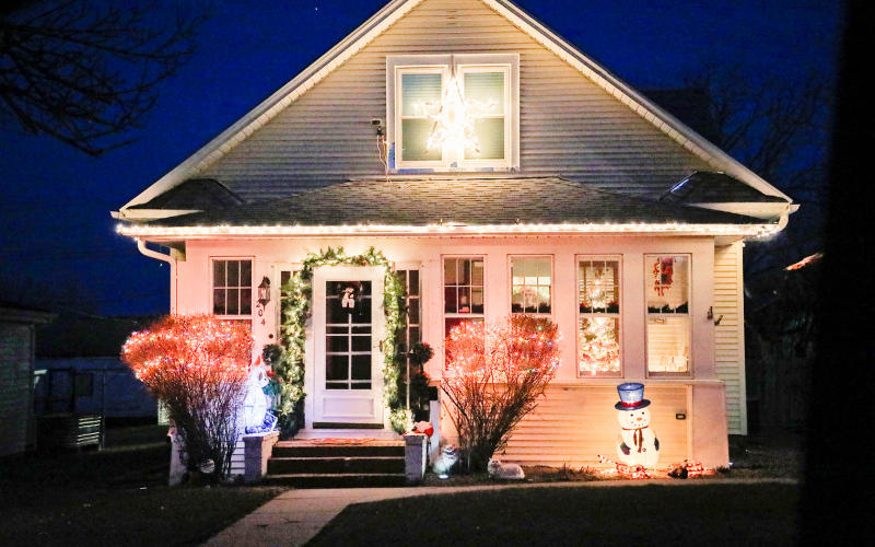The Marcus and Lynn Damm house welcomes holiday visitors with a bright cheery entry.