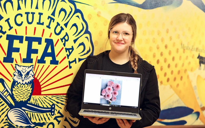Thanks to being awarded a $1,000 grant from National FFA, WSHS sophomore Mercedes Jones will make an investment in her family’s flower farm, purchasing specialty dahlia tubers and low tunnel equipment. She displays an example of the specialty dahlias on her laptop in the hallway leading to the shop at WSHS.