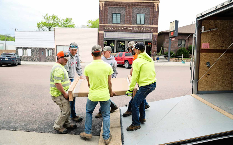 Muscle, in the form of city employees and summer help was needed and graciously accepted to unload and place the table.
