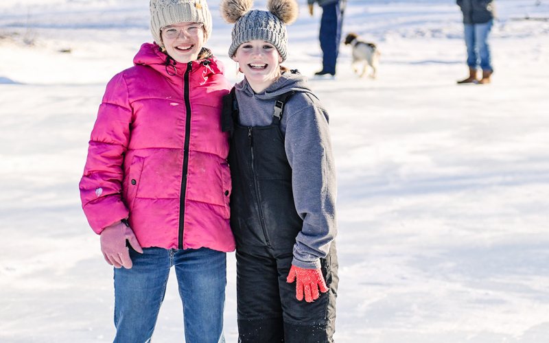 Madilyn Gaikowski and Jalene Reiner enjoy the ice skating rink.