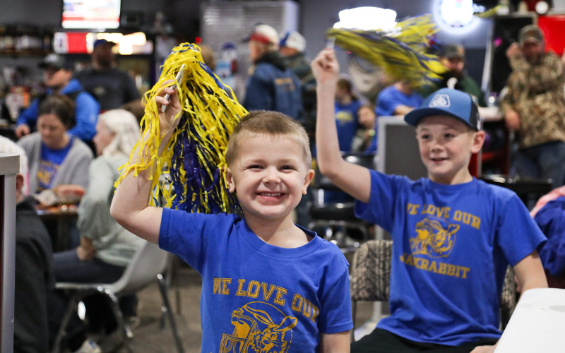 Cecil Fagerhaug leads a group of kids in cheering for the Jacks.