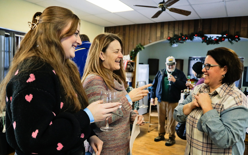 Maddie Neely and Lynn Damm visit with Laura Baker about South Dakota wines featured at the event.