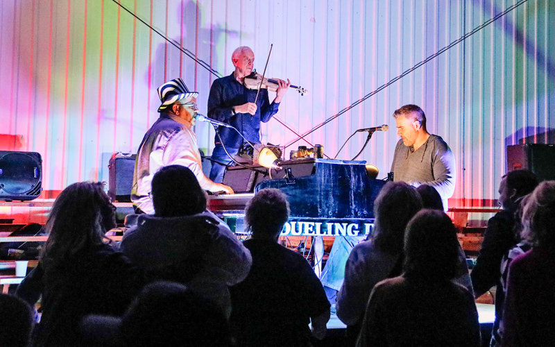 The Dueling Duo, made up of Andy Gibson and Ryan Merriam (Ryno) on vocals and piano and the four-instrument talents of Dan Witte, lit up the night at the Alpena Community Center Saturday night.