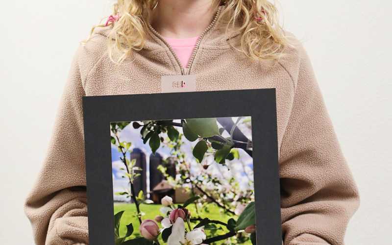 Alexis Rosler with photograph “Springtime on the Farm.”