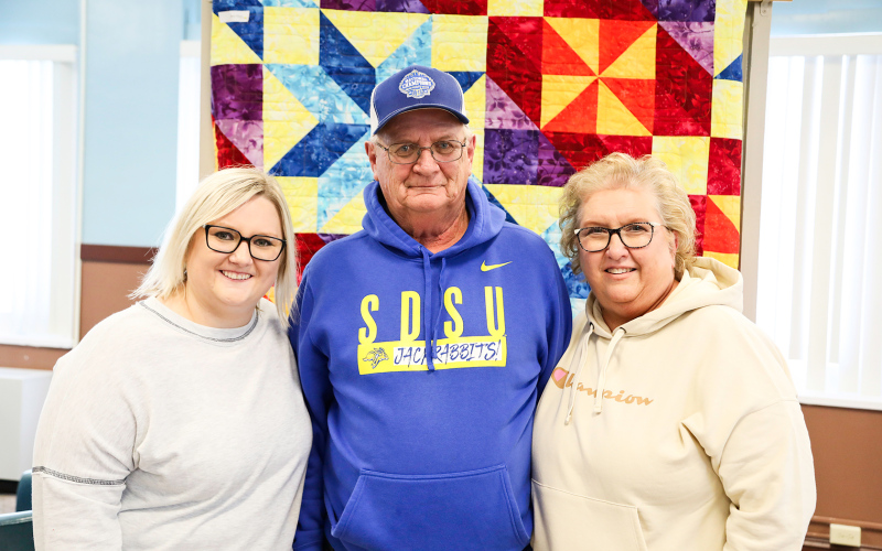 Of the many friends, family and coworkers in attendance, Larson is shown with his daughter Kelsey (left) and wife Connie.
