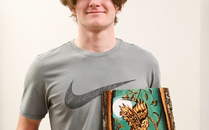  Wynand Bothma with 3-D piece “Sitting Bear,” second place and “Grim Reality,” 3rd place in the Mixed Media division.