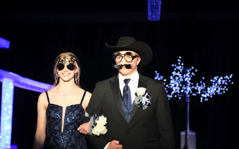 Bailey Yost is escorted by a cleverly disguised Robbie Hine.
