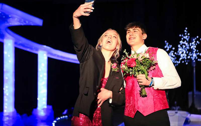 Abby Kolousek, escorted by Blake Miller, snaps a selfie of the prom-goers.