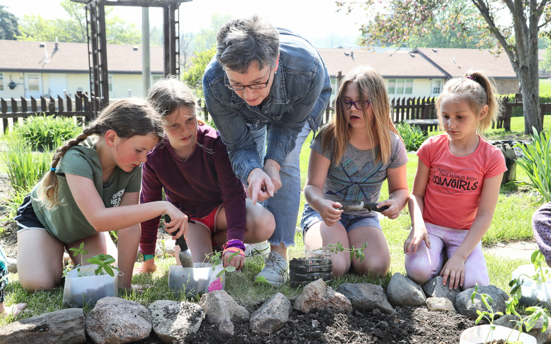 Fastnacht (center) is shown with second grade students (from left) Emme Havlik, Alice Heumiller, Memphis Hanson and Tatum Powell. After months of researching the best flower to plant in their flower bed within the time frame they were given, second graders nurtured zinnias in the classroom, eagerly awaiting the day they would be able to plant the flowers in the ground at Shakespeare Garden.