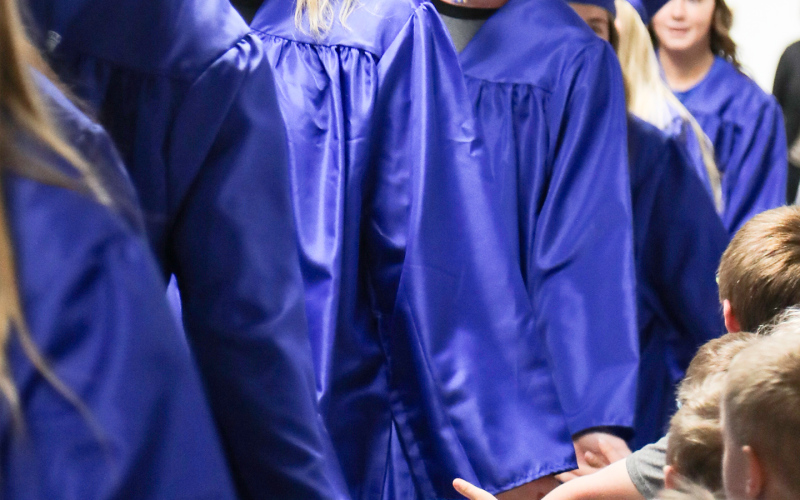 Pictured high-fiving elementary school students are seniors Brock Kruger, Avery Orth and Wynand Bothma.