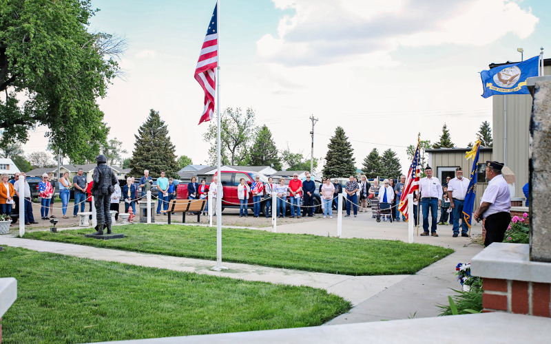 Across Jerauld County, locals and visitors gathered together in Alpena, Wessington Springs and at rural cemeteries to pay tribute to the veterans and the sacrifices they made so that life can carry on every day in a free America. In Alpena, following a powerful presentation delivered by David A. “Bear” Burnison inside the Alpena Community Center, attendees gathered outside for a prayer at the Alpena Veteran’s Memorial.