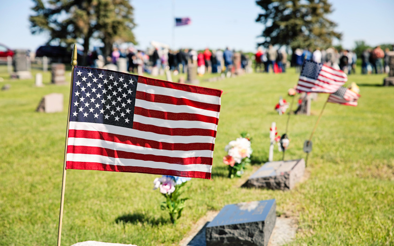 American flags, flowers and mementos decorate the graves at rural Hope Cemetery, where a large crowd gathered for a Memorial Day program Monday.
