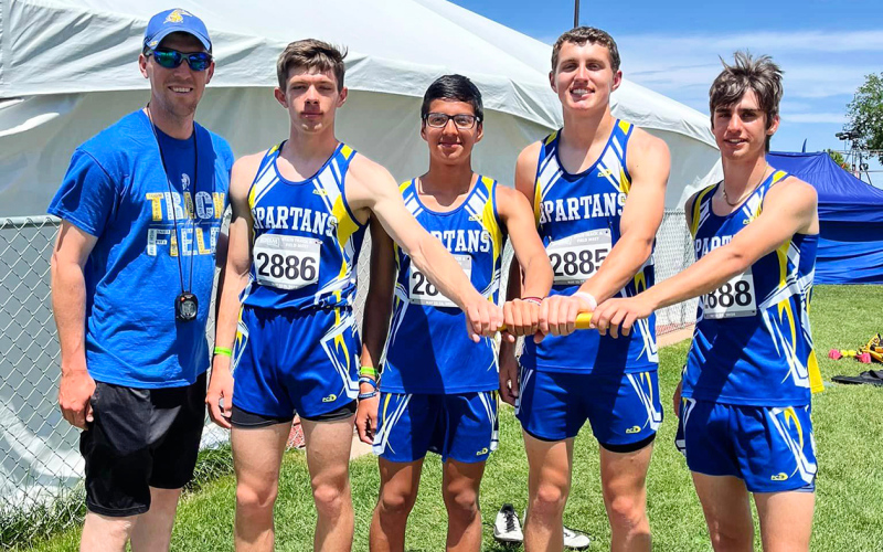 Taking the baton to the track in the boys’ two mile relay were Karter Mebius, Richard Cardona, Brock Krueger, and Sam Poncelow, shown with Coach Drew Kraft. PHOTO COURTESY BECKY KRUEGER