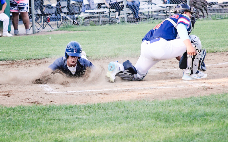 Blake Larson slides home during amateur baseball action versus the Kimball /White Lake Nationals.