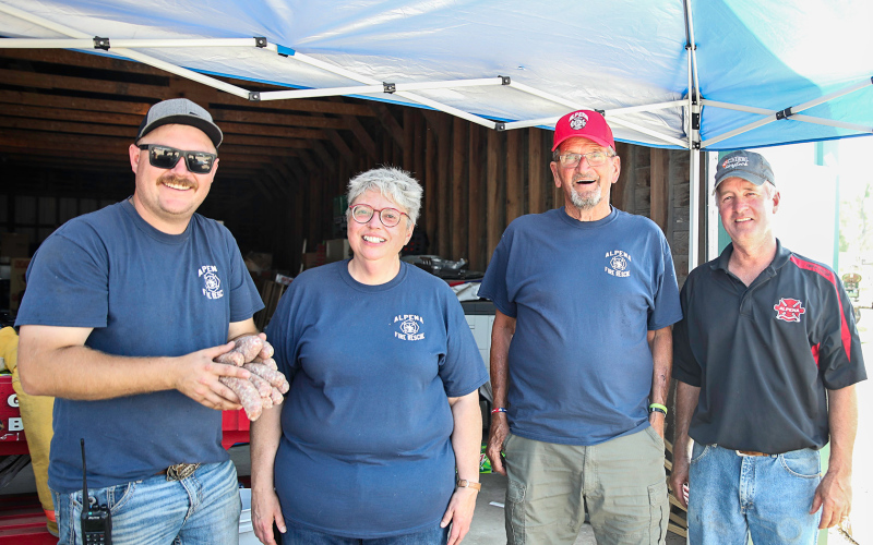 Alpena first responders volunteered selling burgers and brats throughout the tractor pull event.  Shown left to right are: Fire Chief Ryder Schweitzer, Linda Schacht, Gary Orth and Jim Scheel.