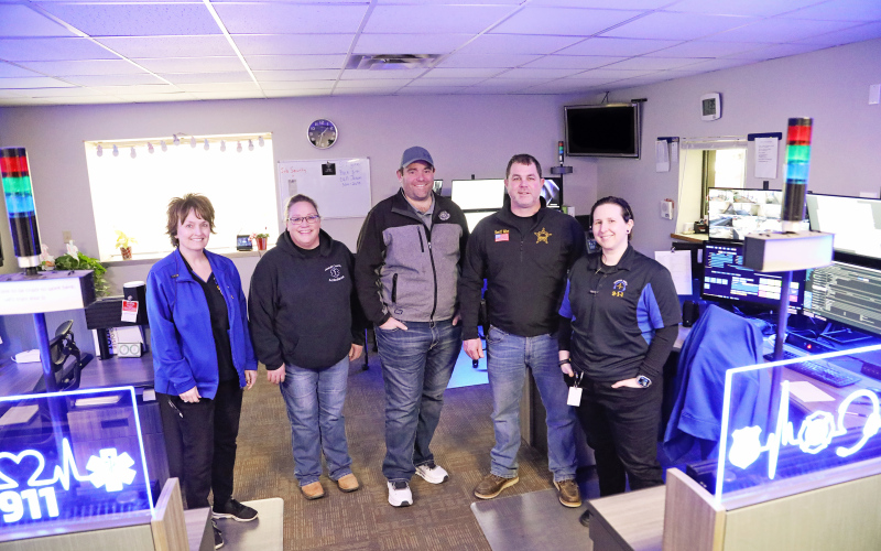 Shown at the Huron 911 Dispatch Center are, left to right: Lisa McWethy, 911 Telecommunications Dispatch Supervisor; Deb Fastnacht, Jerauld County Ambulance Director; Eric Schroeder, Wessington Springs Fire Chief; Jerauld County Sheriff Jason Weber; Kaeden Nelson-Hare, 911 Telecommunication Dispatcher.
