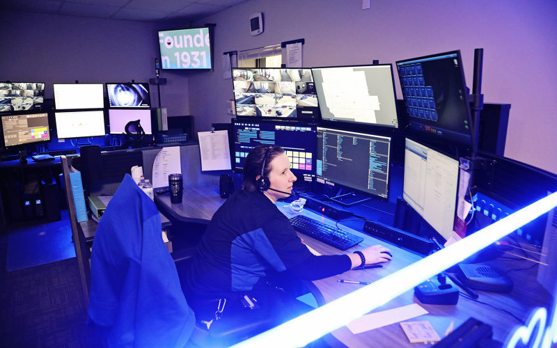 911 Telecommunication Dispatcher Kaeden Nelson-Hare assists a caller from her workstation at the Huron 911 Dispatch Center in the Huron Police Department.