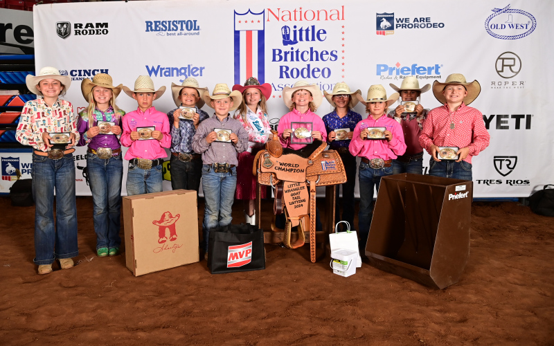 Lawson Fagerhaug, pictured at far right holding his first-ever buckle at a national finals, is among the top 10 in the world for goat tail untying. PHOTO COURTESY BY PHIFER/RODEO BUM