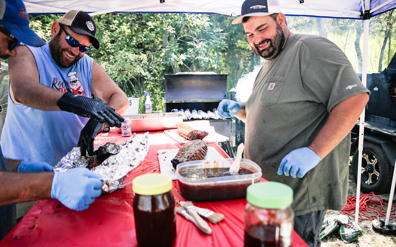 Brady Younie, Eric Schroeder and Chris Cashman enjoy a laugh while working on their ribs.