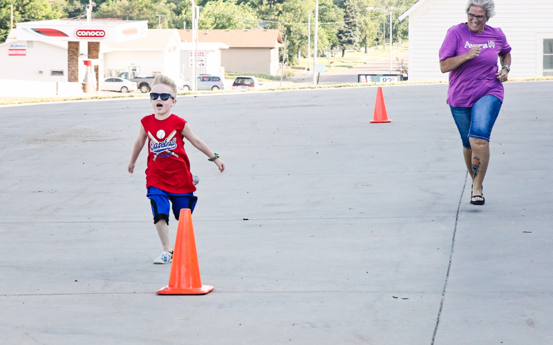 Axle Kurth and can’t contain his excitement during the kid fun run at the fire hall. He is shown with one of the event organizers Lori Van Den Oever.