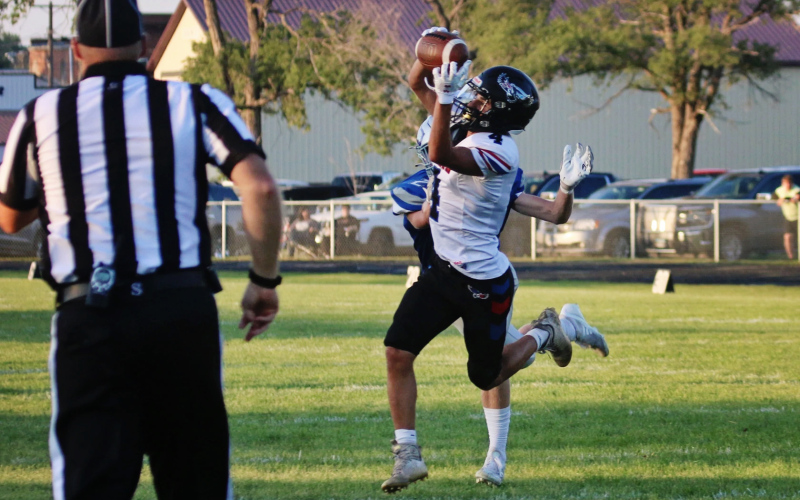 Wessington Springs/ Woonsocket/Sanborn Central's Sam Poncelow (4) leaps to make a catch, scoring a touchdown for the Blackhawks during a Class 11B football game on Friday, Aug. 23, 2024, in Bridgewater. PHOTO: Blake Durham / Mitchell Republic