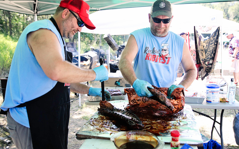Scott Miller and Brian Kolousek work fast and furious to process ribs by the judges deadline.