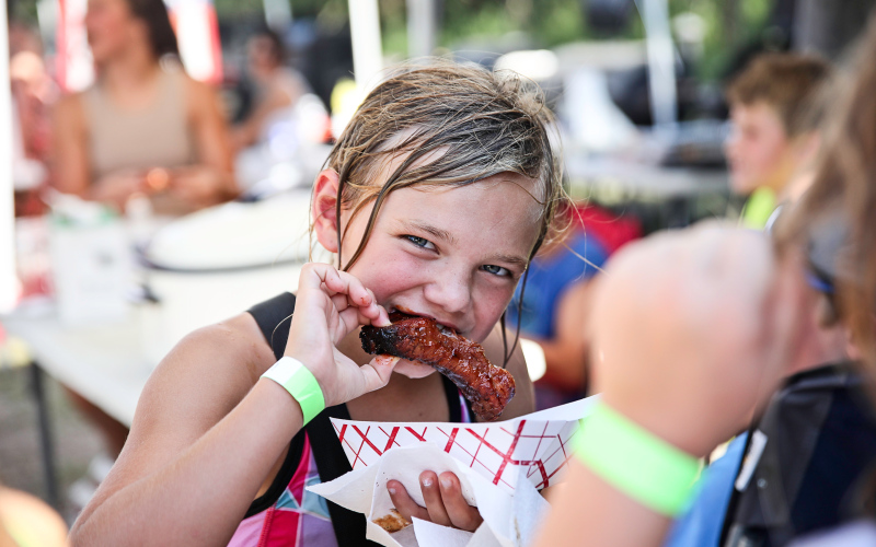 Carlayna Waters cooled off in the pool then returned to the park to sample the wide variety of ribs prepared by 13 different contestants.