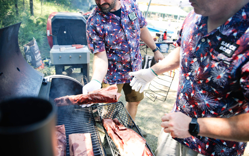 Jason Weber and Jarrod Bultsma range ribs in the smoker.