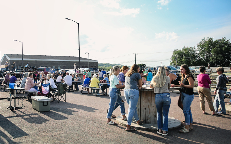 A large crowd gathered on Main Street in front of Pin Twisters following the Sons of American Legion Poker Run for a community supper and live musical entertainment Saturday.