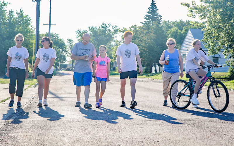 Following the run, they’re off and walking the annual 1.5 mile route through town. Shown left to right are: Kim and Cheyenne Burg, Mike Mebius, Carolina Mebius, Max Mebius, Eileen Thomas and Madi Mebius.