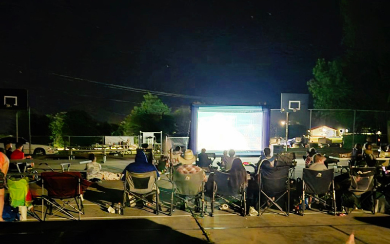 PHOTO COURTESY LOREE GAIKOWSKI The tennis courts in the city park were transformed into an outdoor movie theater Friday at dark.