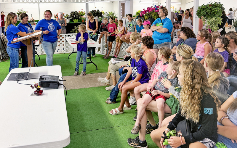 The national qualifying Wessington Springs FFA Floriculture team did a demonstration at the Horticulture Building on floral design and helped kids make flower arrangements to take home. The team made up of Mariah Messmer, Anna Arhart, Mercedes Jones, Carissa Scheel and Alyssa Grohs helped children create 50 flower arrangements in about 40 minutes. PHOTO COURTESY KATIE JONES PHOTOGRAPHY