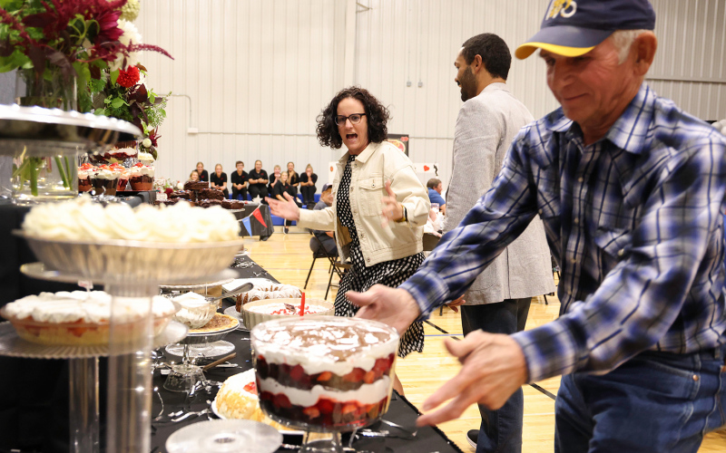 Dashing for desserts as part of the fundraiser, Teri Bergeleen, Joey Mitchell and Elton Kaus vie for sought-after treats to bring back to their tables. KRISTI HINE / TRUE DAKOTAN