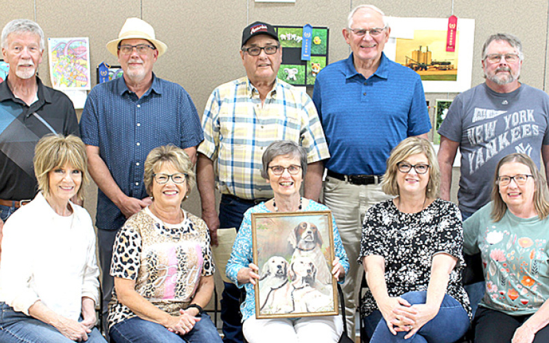 Cousins shown front row, left to right: Del Lomhein, Barb Murphy, Linda Roth holding one of Fred Mohling’s paintings, Karla Moody and Joan Swanson. Back row: Mike Lomheim, John Swanson, Kieth Mohling, Bill Roth and Karl Swanson.