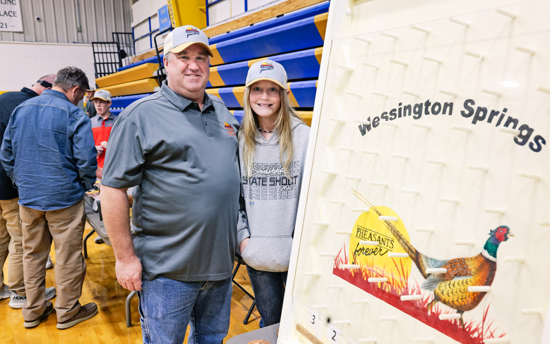 Aaron Roesler with daughter Lily are shown with one of the many games featured at the banquet. The event also boasted a wide variety of raffles and a live auction.