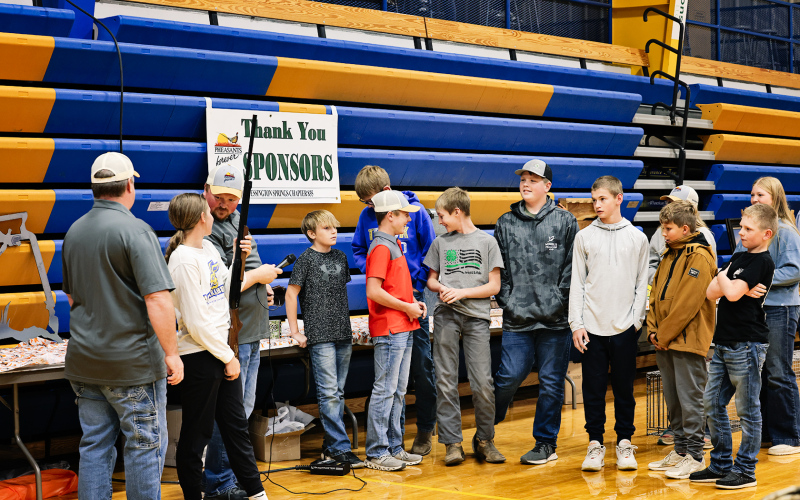 Members of the Pheasants Forever Youth Hunt line up to see who won the gun raffle.