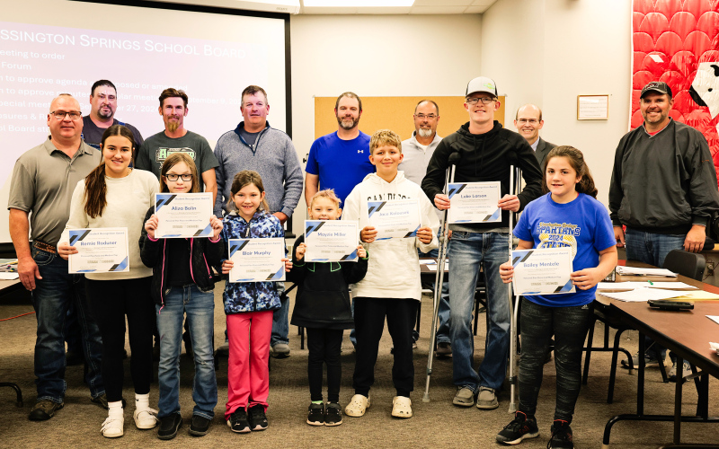 Pictured, back row: BOE members Darrick Van Dyke, Derek Zastrow, Scott Kolousek, Dustin Weber, Gene Gaikowski, Superintendent Dr. Michael Ormsmith, BOE member Jonathan Arhart. Front row: Humm-Dinger owner Jason Zacher, students Remie Roduner, Aliza Bolin, Blair Murphy, Mayzie Miller, Jace Kolousek, Luke Larson, Bailey Mentele. KRISTI HINE / TRUE DAKOTAN